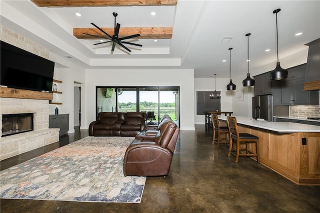 7532 Marys Way, Bryan, TX 77808 - living room with a ceiling fan, a fireplace, concrete floors, a raised ceiling, and recessed lighting