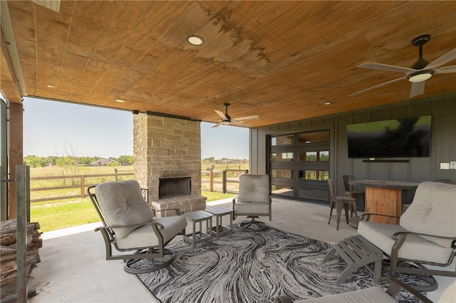 7532 Marys Way, Bryan, TX 77808 - view of patio with an outdoor stone fireplace, fence, and a ceiling fan