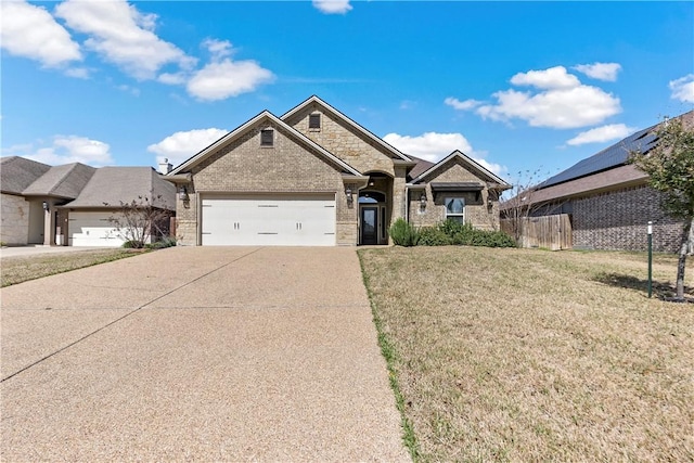 view of front facade featuring brick siding, concrete driveway, a front yard, fence, and a garage