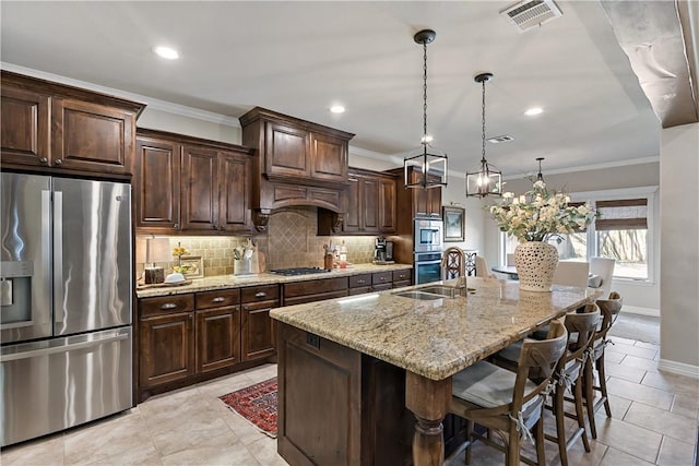 kitchen featuring light stone counters, a sink, visible vents, appliances with stainless steel finishes, and decorative backsplash