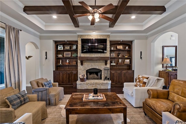 living room featuring a fireplace, arched walkways, coffered ceiling, and wood finished floors