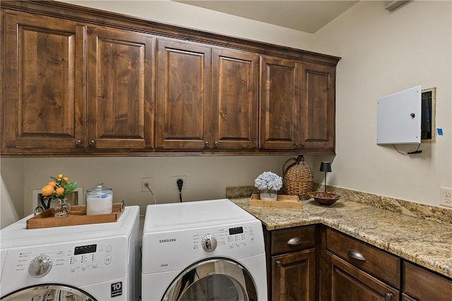 washroom with cabinet space and washing machine and clothes dryer