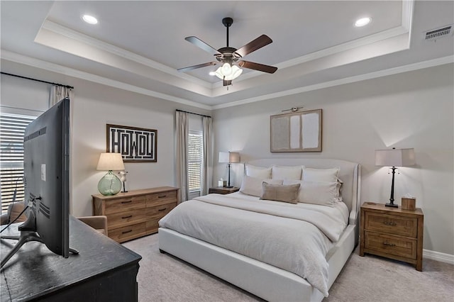 bedroom featuring a tray ceiling, light colored carpet, crown molding, and visible vents