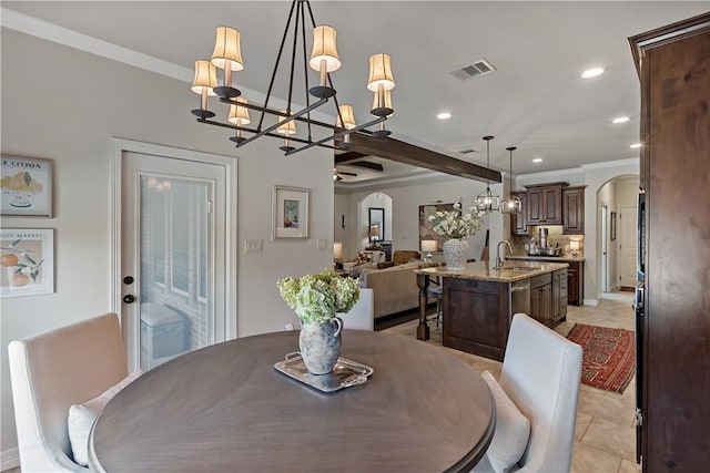 dining area featuring arched walkways, recessed lighting, visible vents, ornamental molding, and light tile patterned flooring