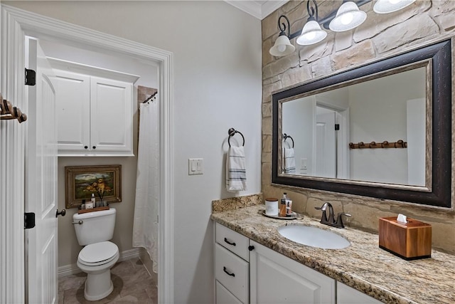 bathroom featuring toilet, tile patterned floors, baseboards, and vanity