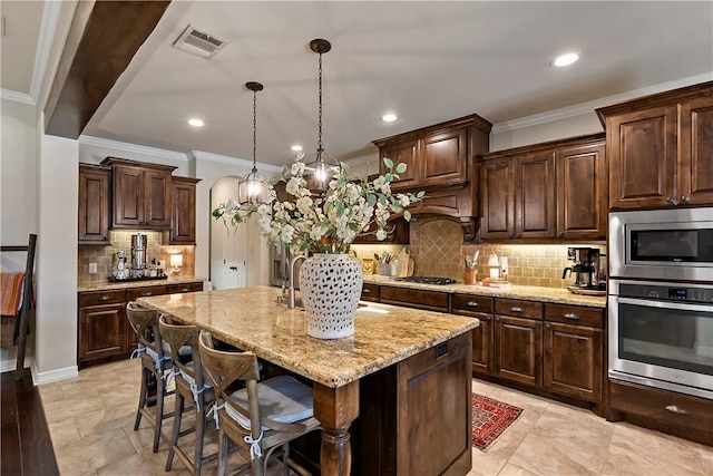 kitchen with light stone countertops, visible vents, appliances with stainless steel finishes, and ornamental molding