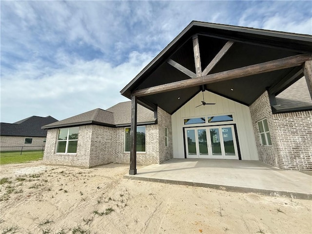 3201 Hunters Crossing Trl, Bryan, TX 77808 - rear view of property featuring ceiling fan, brick siding, a patio area, and french doors