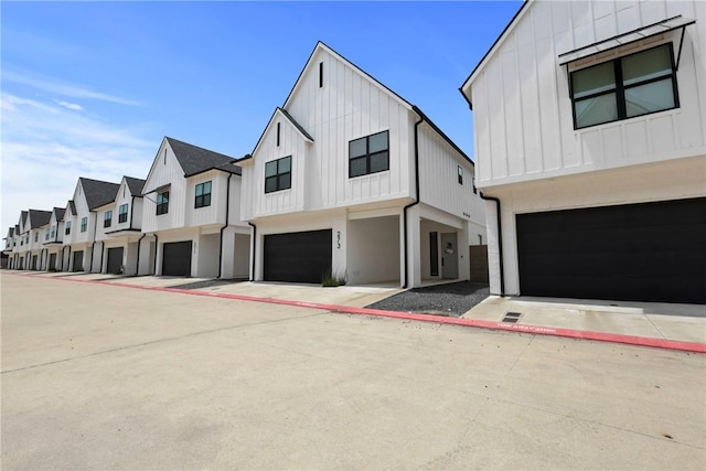 273 Estates Cir, College Station, TX 77840 - view of front of house featuring board and batten siding, an attached garage, and a residential view