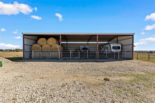 view of horse barn featuring a rural view