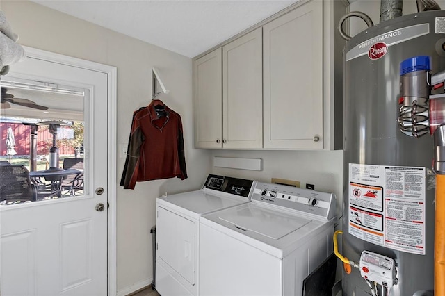 washroom with separate washer and dryer, cabinets, and gas water heater