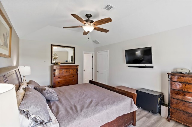 bedroom with ceiling fan, light wood-type flooring, and lofted ceiling