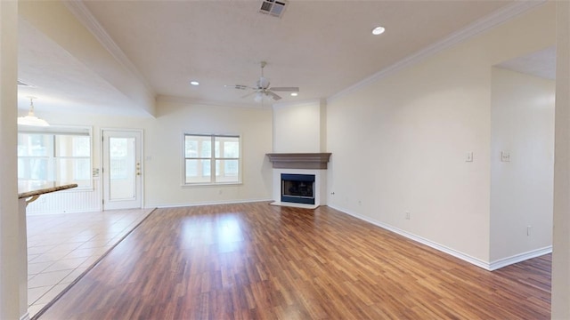 unfurnished living room featuring crown molding, ceiling fan, and hardwood / wood-style flooring