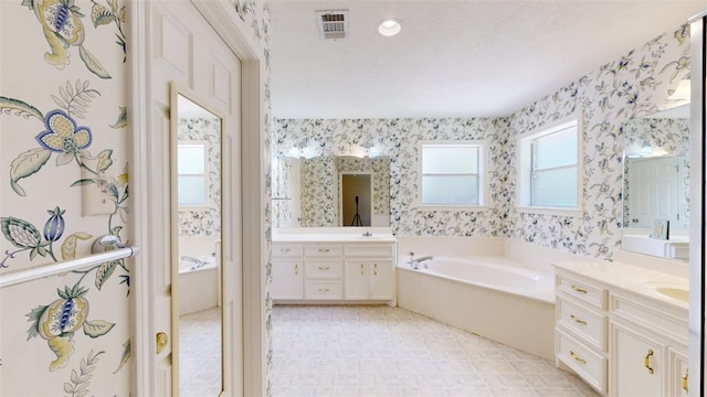 bathroom with vanity and a tub to relax in