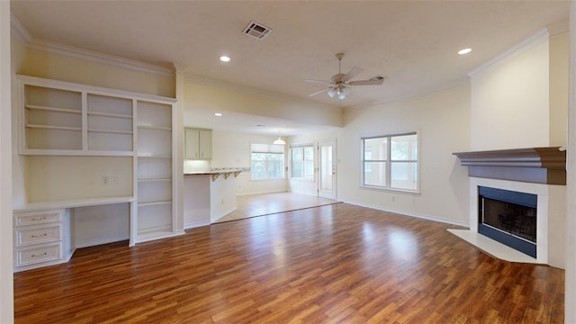 unfurnished living room with ornamental molding and wood-type flooring