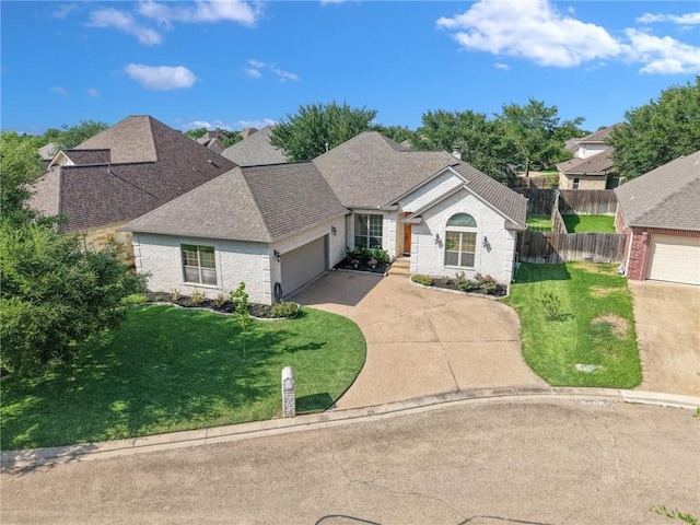 4413 Hearst Ct, College Station, TX 77845 - view of front of house with driveway, a garage, brick siding, and roof with shingles