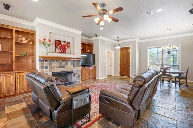 4413 Hearst Ct, College Station, TX 77845 - living area featuring stone tile floors, a chandelier, a ceiling fan, a tile fireplace, and crown molding