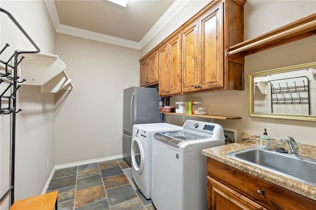 4413 Hearst Ct, College Station, TX 77845 - laundry area with washing machine and dryer, crown molding, dark stone finish flooring, and cabinet space