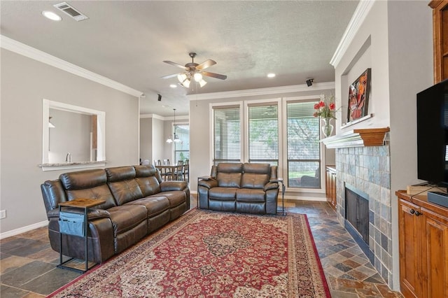 4413 Hearst Ct, College Station, TX 77845 - living room with stone tile flooring, a ceiling fan, a tiled fireplace, ornamental molding, and recessed lighting