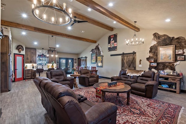 living area featuring vaulted ceiling with beams, baseboards, a barn door, an inviting chandelier, and wood finished floors