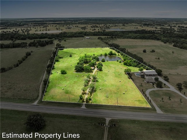 birds eye view of property with a rural view and a water view