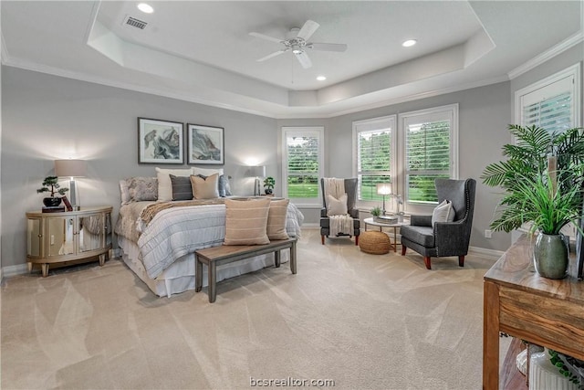 bedroom featuring light colored carpet, a raised ceiling, ceiling fan, and ornamental molding