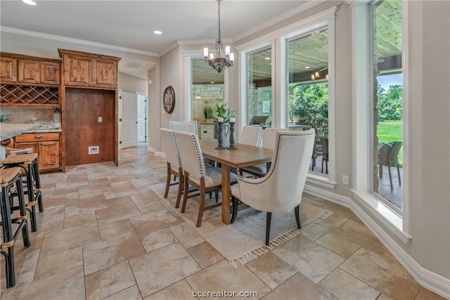 dining area featuring plenty of natural light, ornamental molding, and an inviting chandelier