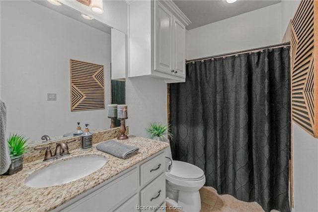 bathroom with toilet, vanity, and tile patterned floors