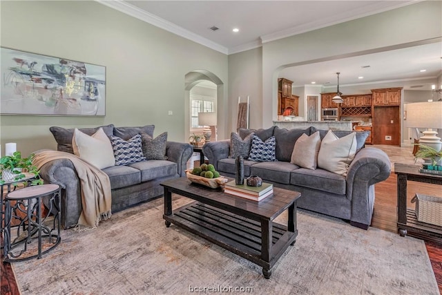 living room featuring light hardwood / wood-style floors and crown molding