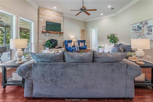 living room featuring dark hardwood / wood-style floors, ornamental molding, and a fireplace