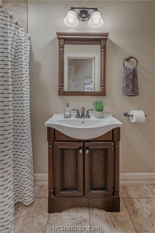 bathroom featuring tile patterned floors, vanity, and a shower with shower curtain