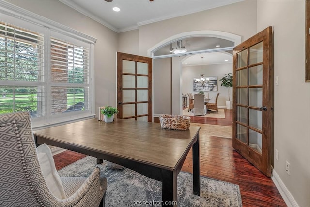 office featuring an inviting chandelier, crown molding, dark wood-type flooring, and french doors