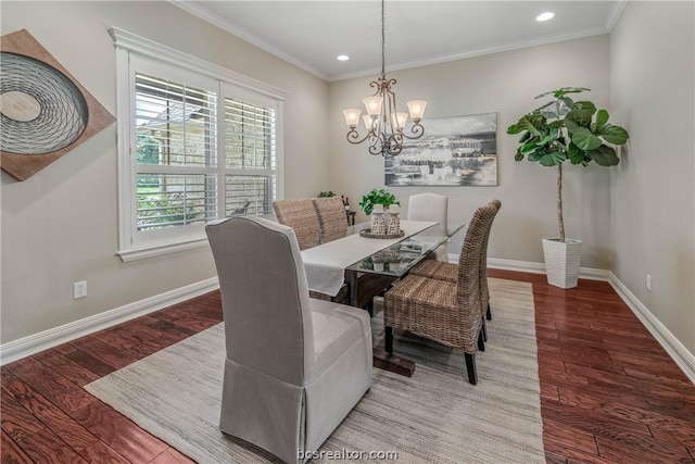 dining room featuring hardwood / wood-style flooring, crown molding, and a notable chandelier