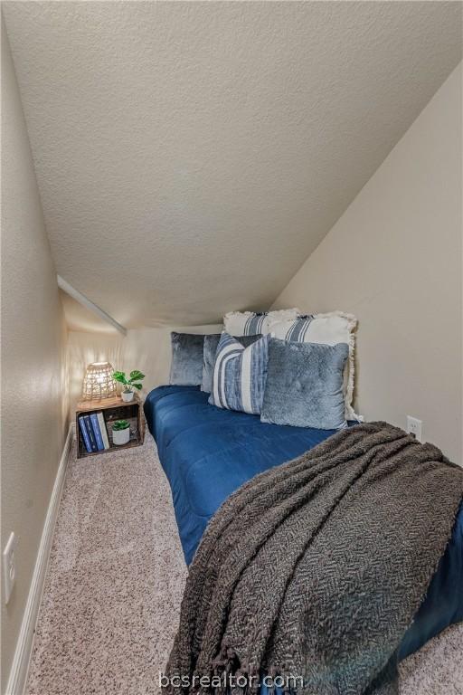 bedroom featuring a textured ceiling and carpet floors