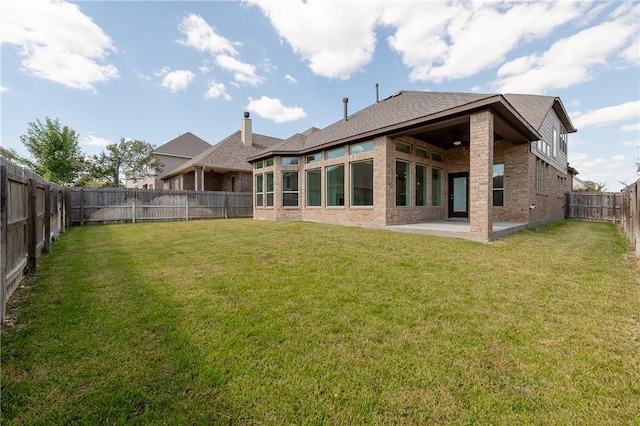 back of house featuring a patio and a lawn