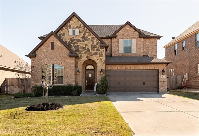 view of front of property featuring a garage and a front lawn