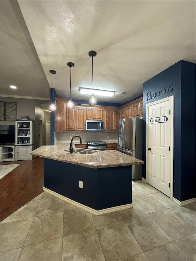 kitchen featuring kitchen peninsula, hanging light fixtures, light stone countertops, sink, and appliances with stainless steel finishes