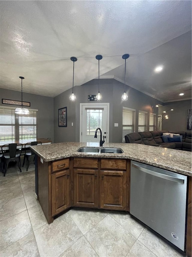 kitchen featuring sink, stainless steel dishwasher, vaulted ceiling, and pendant lighting