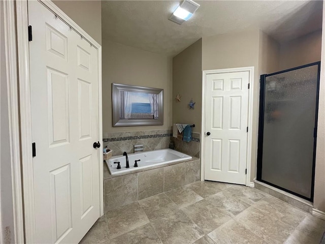 bathroom featuring separate shower and tub