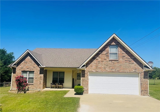 525 Oak Tree Ln, Franklin, TX 77856 - view of front of property with a garage, brick siding, a front yard, and concrete driveway
