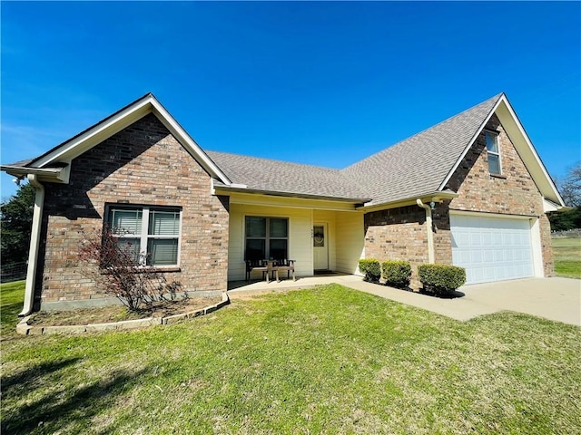 view of front of property featuring a front yard, a garage, and a patio area