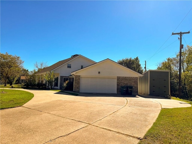 ranch-style house with a storage unit, a garage, and a front yard