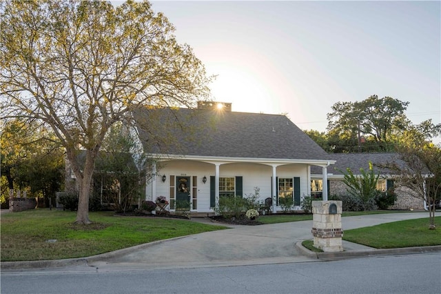 view of front of house featuring covered porch and a front lawn