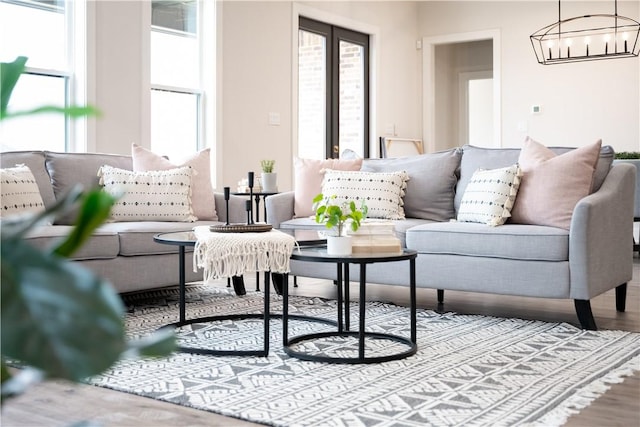 living room featuring a chandelier, hardwood / wood-style floors, and a wealth of natural light