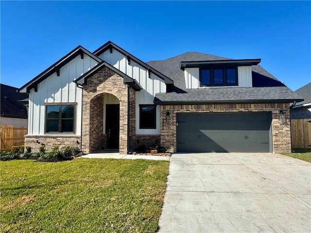 view of front of home featuring a front yard and a garage