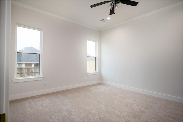 carpeted empty room with ornamental molding and ceiling fan