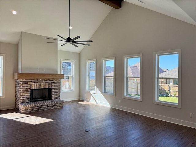 unfurnished living room featuring ceiling fan, dark wood-type flooring, a brick fireplace, beamed ceiling, and high vaulted ceiling