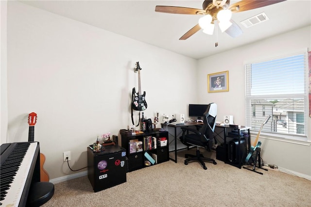 office space with baseboards, carpet flooring, ceiling fan, and visible vents