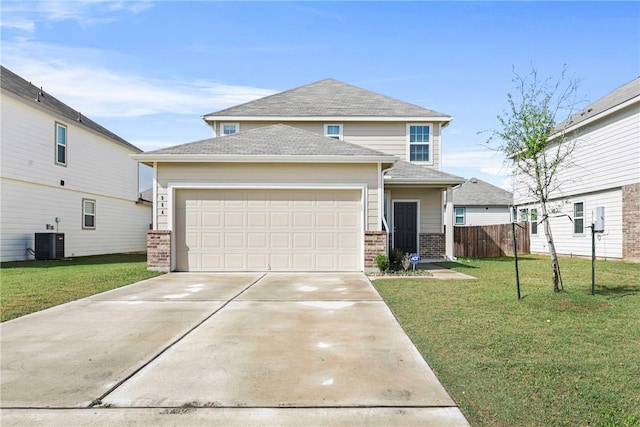 traditional-style house with concrete driveway, a front yard, brick siding, and a garage