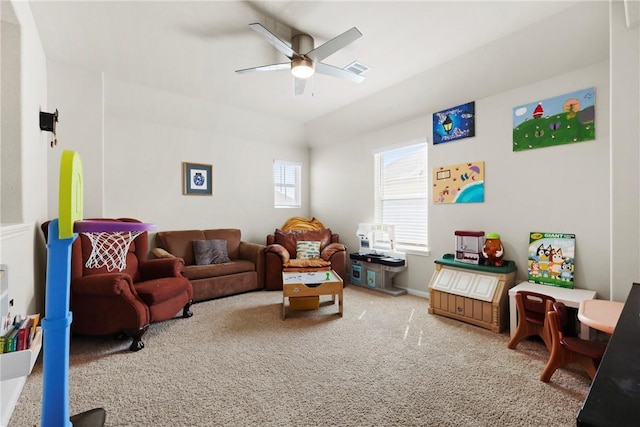 recreation room with baseboards, visible vents, a ceiling fan, and carpet flooring
