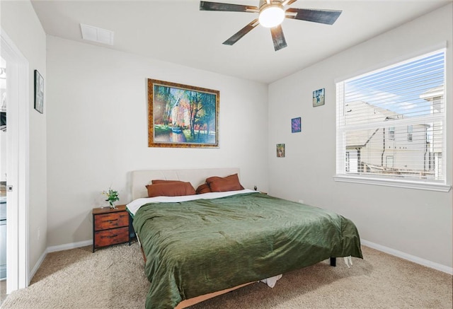 bedroom featuring visible vents, ceiling fan, baseboards, and light carpet